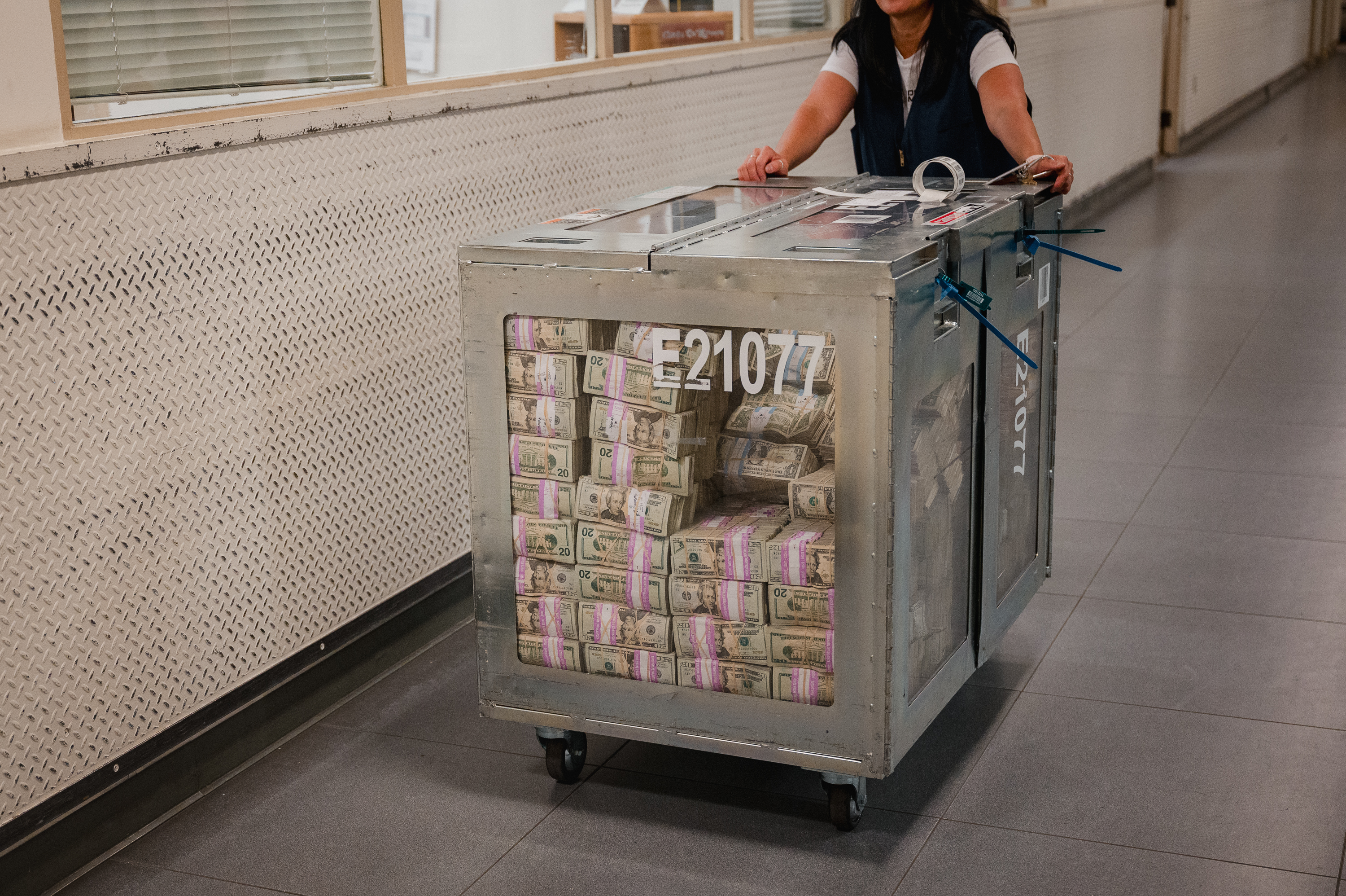 An employee moves containers of currency to the processing room at the Federal Reserve Bank of Richmond in Baltimore on July 12.